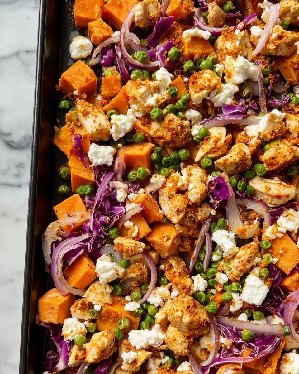 The image shows a close-up of a tray filled with a colorful mixed dish. It has several layers including bright orange cubed sweet potatoes scattered across the bottom, chunks of white and light brown crispy chicken pieces layered on top, small green peas sprinkled throughout, and thin strips of purple cabbage spread over the mix. The textures vary from soft sweet potatoes and crunchy chicken to fresh crunchy cabbage. The tray holding the food is a dark metal rim, and the scene is set on a white marbled texture. photo taken with an iphone --ar 4:5 --v 7