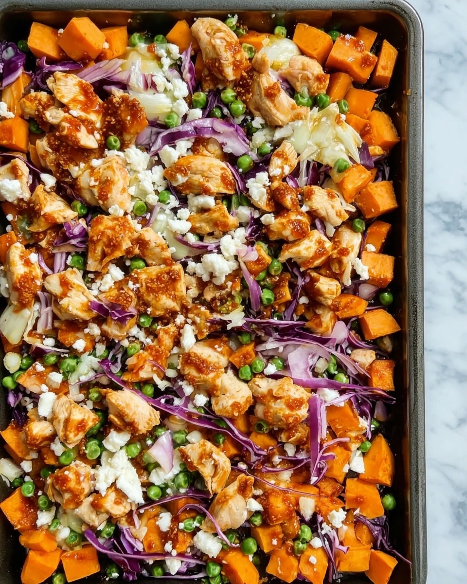 The image shows a tray filled with a colorful mix of roasted diced orange sweet potatoes as the base layer, topped with chunks of cooked chicken coated in a slightly reddish sauce. Scattered among the potatoes and chicken are small green peas and thin strips of purple cabbage. Small bits of white cheese are sprinkled unevenly over the top, adding contrast to the warm tones. The ingredients appear well mixed but still distinct, with a textured and hearty look. The tray sits on a white marbled surface. photo taken with an iphone --ar 4:5 --v 7